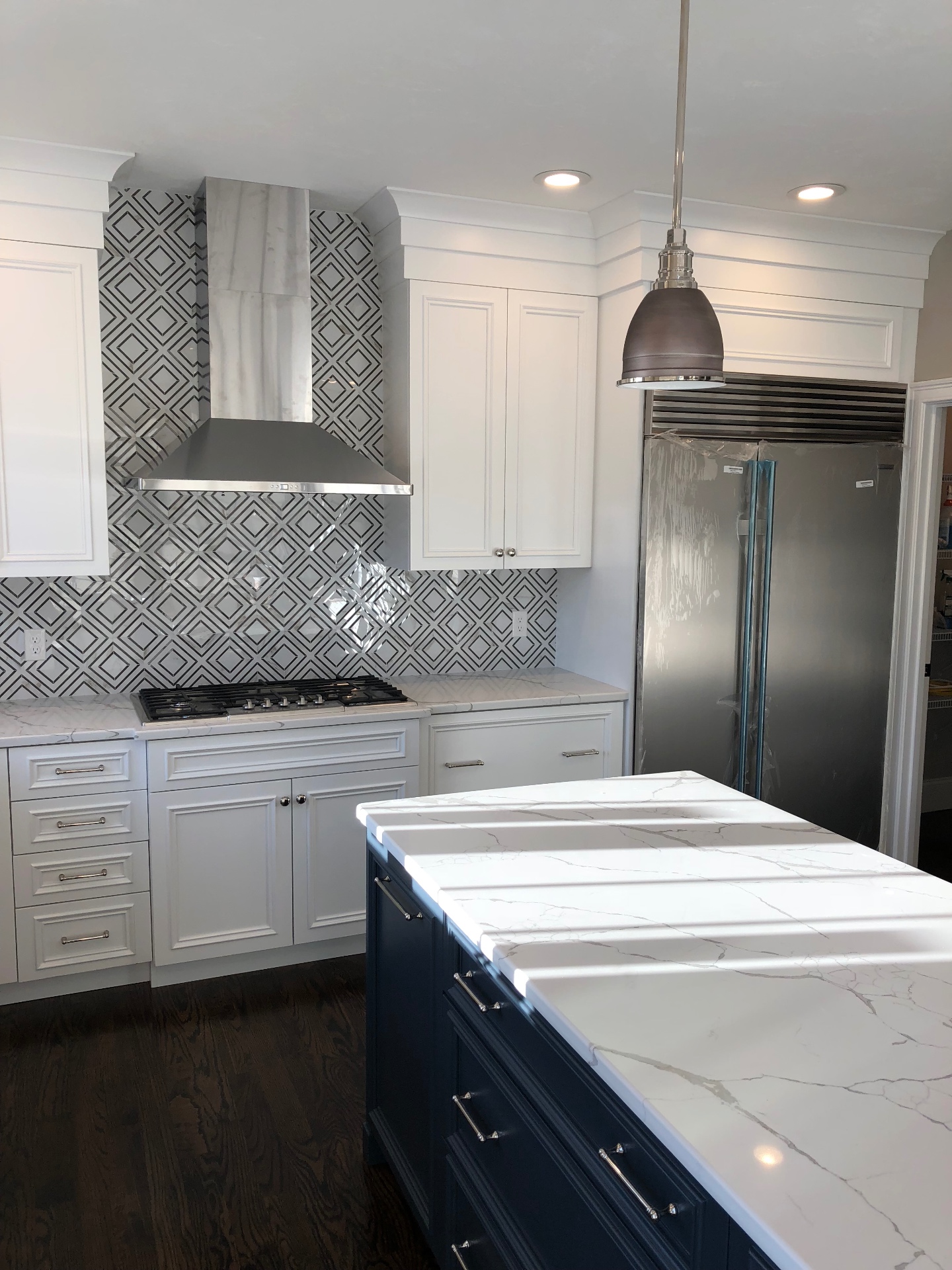 Marble kitchen with navy island built by Hanna Construction